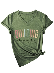 Detail of dark green V-neck T-shirt with 'Quilting' slogan print and stylish side knot
