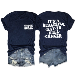 Détail du slogan Oncology Nurse et de l'imprimé blanc sur un t-shirt bleu marine à col rond