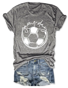 Detail of grey game day football t-shirt paired with distressed denim shorts on white