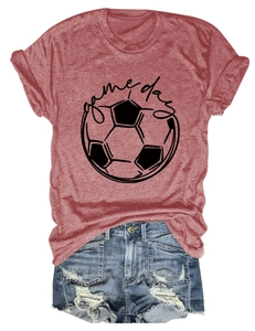 Flat lay of a brick red Game Day soccer t-shirt paired with distressed denim shorts