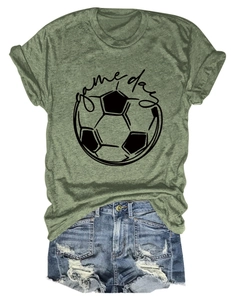 Close-up of olive green t-shirt with Game Day print and ripped denim shorts