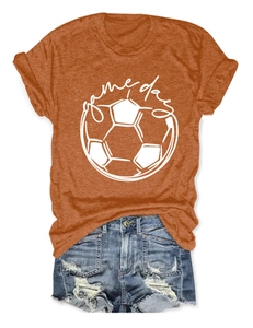 Detail of orange Game Day football t-shirt paired with blue distressed denim shorts