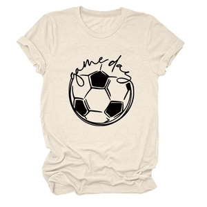Detail of the cotton fabric texture and game day soccer print on a beige t-shirt