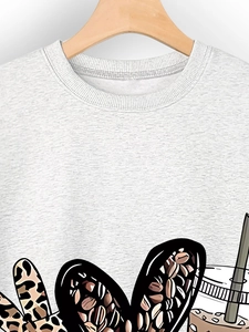 Detail of coffee and bunny illustration on light grey crewneck sweatshirt