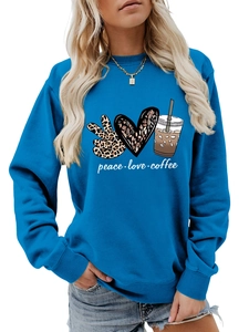 Close-up of royal blue crewneck sweatshirt featuring leopard peace, heart, and coffee graphics