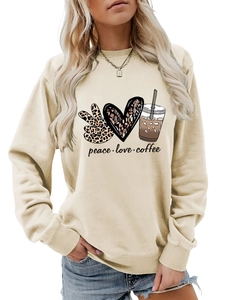 Close-up of peace love coffee graphic print on beige long sleeve sweatshirt for women