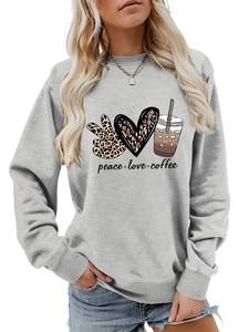 Detail of the peace love coffee print and leopard patterns on light grey sweatshirt