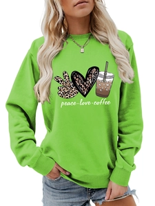 Detail of peace love coffee graphic print on a bright green long sleeve casual sweatshirt