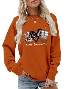 Detail of peace love coffee graphic print on burnt orange long sleeve crewneck sweatshirt