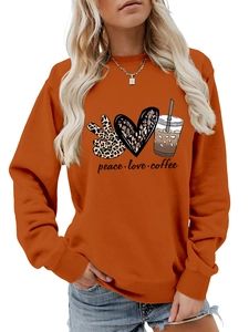 Detail of peace love coffee hand-drawn prints on caramel orange long sleeve sweatshirt
