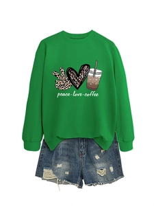 Detail of peace love coffee print on green crewneck sweatshirt with distressed denim shorts