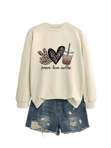 Flat lay of cream long sleeve sweatshirt with peace love coffee print and denim shorts