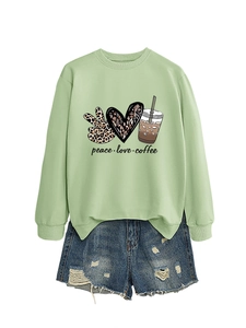 Close-up of peace love coffee graphic print on light green long sleeve sweatshirt