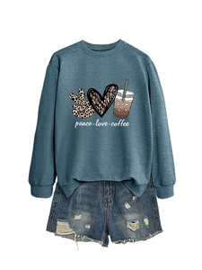 Close-up of peace love coffee print sweatshirt with vintage distressed denim shorts