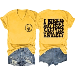 Front and back view of yellow V-neck T-shirt with I Need Way More Tattoos text and denim shorts