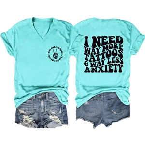 Flat lay of V-neck T-shirt and distressed denim shorts with tattoo slogan print