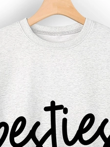 Detail of Besties script print and ribbed neckline on heather gray crewneck sweatshirt