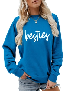 Close-up of blue crewneck sweatshirt featuring white besties script and soft fabric texture