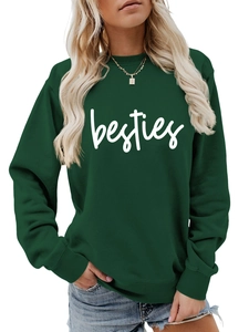 Detail view of the ribbed cuffs and white 'besties' lettering on a green sweatshirt