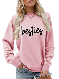 Detailed view of pink crewneck sweatshirt featuring black besties letter print