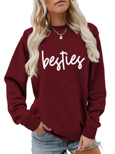 Close-up of the white besties cursive print on a burgundy crewneck sweatshirt fabric