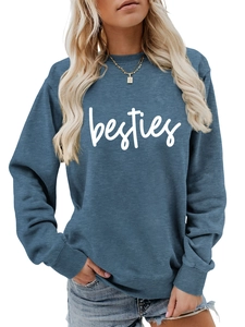Close-up of besties cursive lettering on dark blue crewneck sweatshirt with ribbed cuffs