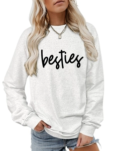 Detail of grey crewneck sweatshirt featuring black besties script print and ribbed cuffs