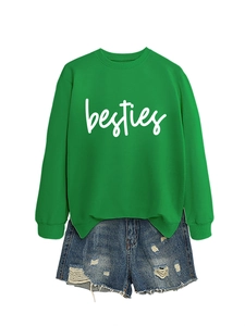 Detail of green round neck sweatshirt with besties text and distressed denim shorts