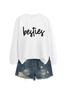 Close-up of white Besties letter print sweatshirt paired with frayed denim shorts
