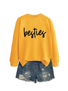 Detail of bright yellow crewneck sweatshirt with black besties lettering and denim shorts