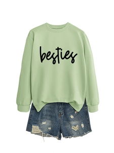 Flat lay of light green drop shoulder sweatshirt with besties print and denim shorts