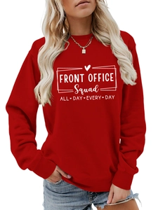 Close-up of the ribbed crewneck and white printed lettering on the red sweatshirt