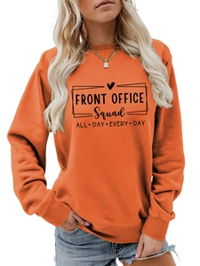 Close-up of bright orange crewneck sweatshirt featuring Front Office black printed slogan