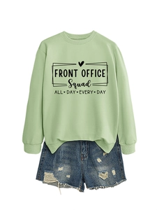 Detail of light green sweatshirt with Front Office Squad print and distressed denim shorts