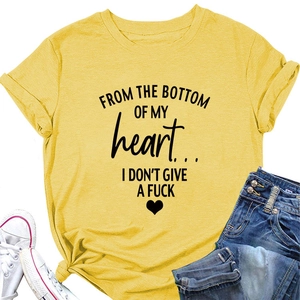 Detail of yellow cotton T-shirt with heart lettering, styled with jeans and sneakers