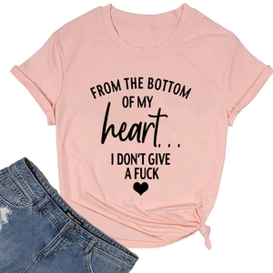 Detailed flat lay of a light pink cotton t-shirt with heart graphic and denim shorts