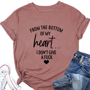Flat lay of dusty rose T-shirt with heart slogan paired with denim and sneakers