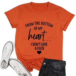 Flat lay of an orange cotton T-shirt with black letter slogans and a small heart icon