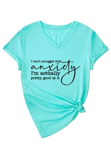 Detail of mint green V-neck T-shirt featuring a knot hem and humorous slogan print