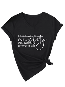 Detail of V-neck T-shirt showing tied hem and white graphic print on black fabric