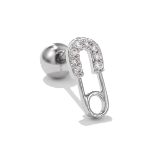 Macro shot of silver safety pin ear stud with sparkling zircon inlay and screw ball back