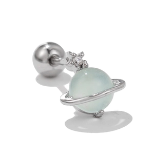 Macro view of a 20G stainless steel Saturn stud earring with green bead and zircon star