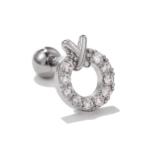 Macro detail of silver stainless steel stud with zircon pavé and screw ball back