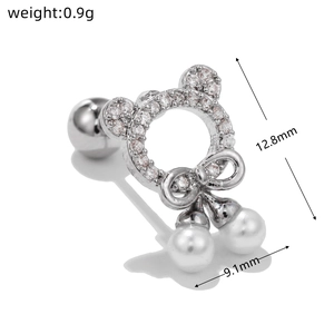 Detailed view of silver bow stud earring with crystal bear and pearls, 12.8mm height
