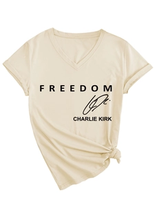 Detailed view of apricot V-neck T-shirt with Freedom Charlie Kirk print and knotted hem