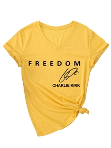 Detail of yellow V-neck t-shirt featuring Freedom Charlie Kirk print and knotted waist