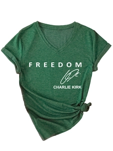 Close-up of green V-neck tee with white Freedom text and knotted hem detail