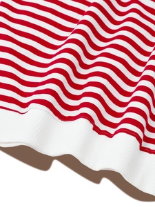 Detail of red and white striped sweatshirt with soft ribbed hem and knit texture