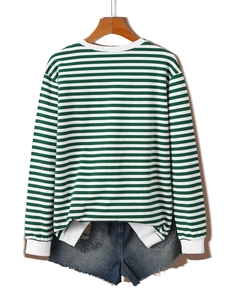 Detail of green and white striped sweatshirt with ribbed cuffs and frayed denim shorts