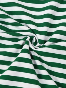Close-up of green and white striped knit fabric showing soft texture and flexibility